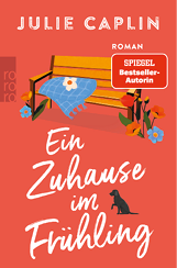 Buchcover mit einer gelben Parkbank, einem blauen Tuch mit wei er Blume, Blumen am Boden und einem schwarzen Hund vor orangem Hintergrund mit dem Titel 'Ein Zuhause im Fr hling' von Julie Caplin